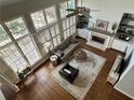 Overhead view of a spacious living room with hardwood floors, fireplace, and large windows at 4658 Glory Maple Trce, Powder Springs, GA 30127