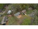 Aerial view showcasing a neighborhood with tree coverage, and houses with driveways at 7535 Asbury Dr, Riverdale, GA 30274