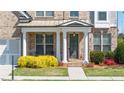 Inviting front porch with white columns and a cozy seating area; great curb appeal at 930 Crestview Dr, Johns Creek, GA 30024