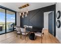 Dining room with modern light fixture, black accent wall, and outdoor views at 2425 Peachtree Ne Rd # 1211, Atlanta, GA 30305