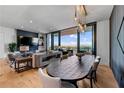 Open living room with hardwood floors, fireplace and scenic balcony views at 2425 Peachtree Ne Rd # 1211, Atlanta, GA 30305