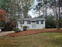 Charming home featuring a neatly landscaped front yard and gray exterior with dark shutters at 4232 Chickasaw Trl, Douglasville, GA 30135