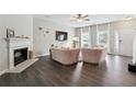 Bright living room with stylish pink sofas, fireplace and hardwood floors at 20 Pine Canyon Sw Dr # 26, Atlanta, GA 30331