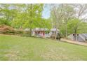 Attractive front yard with mature trees and landscaping leading up to a well-maintained house at 2101 Kinridge Rd, Marietta, GA 30062