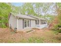 Side view of a gray home, showcasing its garden plot and outdoor space at 2101 Kinridge Rd, Marietta, GA 30062