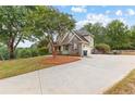 Lovely home featuring a spacious driveway, well-kept lawn, and mature shade trees at 2443 High Meadows Ct, Conyers, GA 30094