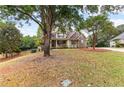 Beautiful home with a well-manicured lawn and mature trees, creating a serene setting at 2443 High Meadows Ct, Conyers, GA 30094