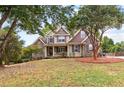 Inviting home with lush front lawn, mature trees, and classic architectural details at 2443 High Meadows Ct, Conyers, GA 30094
