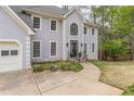 Elegant home featuring a large arched window, two-car garage, and well-maintained landscaping at 275 Sageglen Rd, Lawrenceville, GA 30044