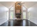 Spacious living room featuring a stone fireplace, high ceilings, and hardwood floors at 275 Sageglen Rd, Lawrenceville, GA 30044