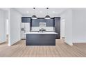 An open-concept kitchen featuring a kitchen island with white countertops and modern cabinets at 2000 Grove Ave, East Point, GA 30344