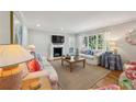 Cozy living room with a fireplace, large windows, and comfortable seating at 2925 Arden Nw Rd, Atlanta, GA 30305