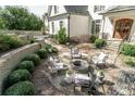 Cozy outdoor fire pit area with stone seating, landscaping, and inviting ambiance at 3224 Lanier Ne Dr, Atlanta, GA 30319