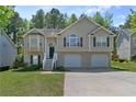 Classic two-story home featuring a two-car garage, mature lawn, and welcoming entrance staircase at 6983 Pine Shadow Way, Winston, GA 30187