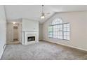 Bright living room with neutral walls, plush carpet, fireplace and a large window for natural light at 6983 Pine Shadow Way, Winston, GA 30187