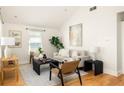 Bright living room features hardwood floors, neutral furniture, large windows, and stylish decor at 91 Chester Se Aly, Atlanta, GA 30316