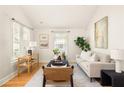 Bright living room features hardwood floors, neutral furniture, large windows, and stylish decor at 91 Chester Se Aly, Atlanta, GA 30316