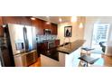 Well-appointed kitchen with stainless appliances, dark cabinetry, and breakfast bar seating at 950 W Peachtree Nw St # 904, Atlanta, GA 30309