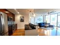 Modern kitchen with stainless steel appliances and granite countertops opens to the living area at 950 W Peachtree Nw St # 904, Atlanta, GA 30309