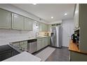 Well-equipped kitchen features stainless steel appliances, updated cabinetry, and white subway tile backsplash at 138 Elysian Nw Way, Atlanta, GA 30327