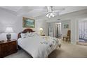 Cozy bedroom with a queen-sized bed, neutral carpet, ceiling fan, and view to bathroom, creating a peaceful retreat at 138 Elysian Nw Way, Atlanta, GA 30327