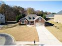 Beautiful home with a long driveway, an attached garage, and a well-maintained lawn at 2105 Rotunda Ct, Conyers, GA 30094