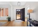 Bright foyer with hardwood floors, an elegant chandelier, and views of the front yard at 2105 Rotunda Ct, Conyers, GA 30094