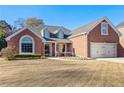 Charming single-Gathering home with brick exterior, manicured lawn and attached two car garage at 2105 Rotunda Ct, Conyers, GA 30094