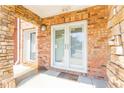 Covered entrance features brick accents and double doors with glass panes and a welcome mat at the base of the door at 217 16Th Nw St # 1, Atlanta, GA 30363