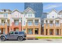 Beautiful townhome exteriors with stone accents, front porches, and a black Jeep parked out front, near the city at 217 16Th Nw St # 1, Atlanta, GA 30363