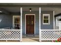 Cozy covered porch showing a stained glass front door, trimmed in white lattice at 3021 Favor Pines Sw Ct, Marietta, GA 30060