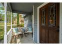 Cozy covered front porch with chairs and a stained glass front door at 3021 Favor Pines Sw Ct, Marietta, GA 30060