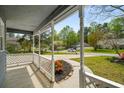 Covered front porch with a manicured lawn and landscape at 3021 Favor Pines Sw Ct, Marietta, GA 30060