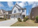 Inviting two-story home features a well-manicured lawn, stone accents, and a convenient two-car garage at 5780 Crestwick Way, Cumming, GA 30040