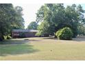 Spacious backyard featuring lush lawn and mature trees, providing ample privacy at 684 N Cherokee N Rd, Social Circle, GA 30025