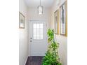 Bright entryway featuring decorative lighting, a white door, and stylish wall art at 875 Edgewater Cir, Marietta, GA 30062