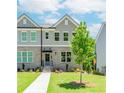 Charming townhome with brick facade, gray siding, manicured lawn and inviting front entrance at 1250 Ainsworth Aly # 42, Sugar Hill, GA 30518