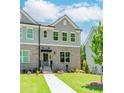 Charming townhome with brick facade, gray siding, manicured lawn and inviting front entrance at 1250 Ainsworth Aly # 42, Sugar Hill, GA 30518