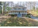 Two-story home with a charming front porch, blue accents, and a view of a sloped front yard at 2887 Swarthmore Dr, Lawrenceville, GA 30044