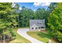 Beautiful single Gathering home boasting a long, curved driveway and a well-manicured lawn at 939 Jean Ct, Covington, GA 30014