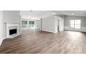 Large, open living room with fireplace, hardwood floors, lots of natural light and open design at 1590 Highland Farm Dr, Suwanee, GA 30024