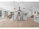Bright kitchen with bar seating, stainless vent hood, and adjacent dining area at 3407 Deerwood Ct, Rex, GA 30273