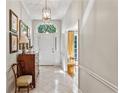 Bright foyer features a vintage dresser, chair, and arched window above the front door at 4590 Lake Forrest Nw Dr, Atlanta, GA 30342