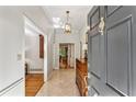 Welcoming foyer with marble floors, a vintage dresser, and an open view into the adjoining living spaces at 4590 Lake Forrest Nw Dr, Atlanta, GA 30342
