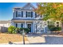 Beautiful two-story home with gray siding, black shutters, well-kept landscaping, and attached garage at 840 Ash St, Canton, GA 30114