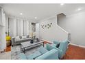 Comfortable living room with a modern sofa, stylish accents, and staircase access at 840 Ash St, Canton, GA 30114