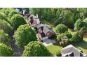 An aerial view of homes nestled amongst lush trees in a desirable neighborhood at 138 Grand Ave, Suwanee, GA 30024