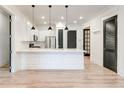Modern kitchen boasts white cabinets, stainless steel appliances, a center island, and sleek black doors at 625 Piedmont Ne Ave # 2004, Atlanta, GA 30308
