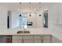 Modern kitchen with stone countertops that overlooks the living room fireplace at 625 Piedmont Ne Ave # 2004, Atlanta, GA 30308