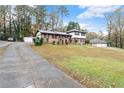 Two-story home featuring a well-maintained lawn, driveway and detached garages at 753 Brookwood Sw Ter, Lilburn, GA 30047